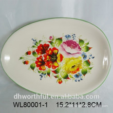 Oval ceramic serving platter with flower and bird decal